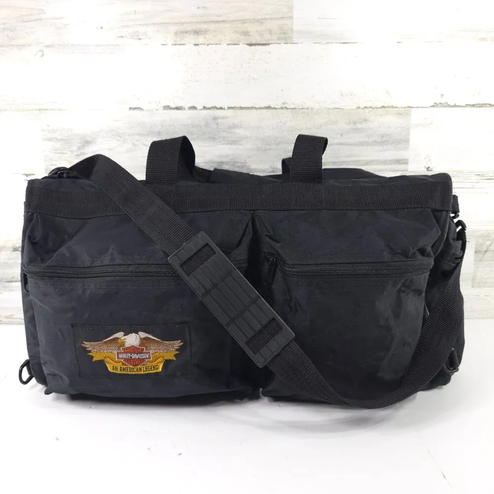 VINTAGE HARLEY DAVIDSON AN AMERICAN LEGEND BLACK DUFFLE BAG WITH SHOULDER STRAP.